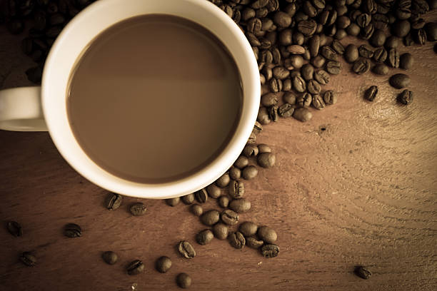 istock coffee and beans wooden table 477980520