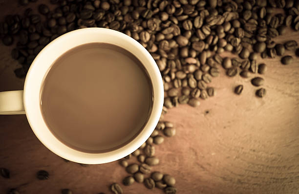 istock coffee and beans wooden table 477980528