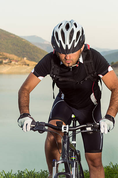 istock Mountain biker beside a beautiful lake 477981895