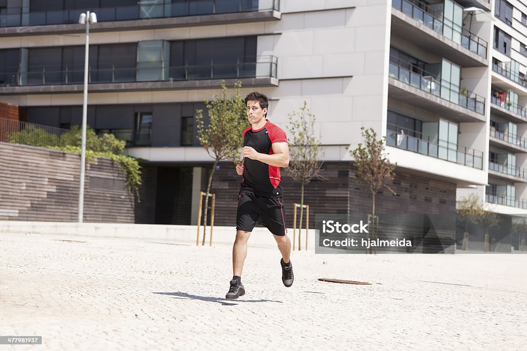 Running athlete Men athlete running at the city park 20-29 Years Stock Photo