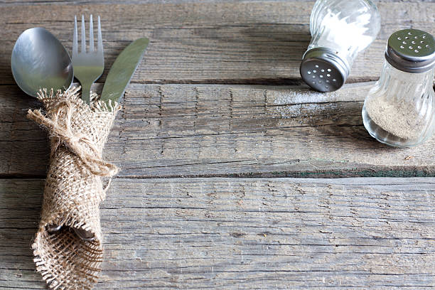 Cutlery kitchenware on old wooden boards