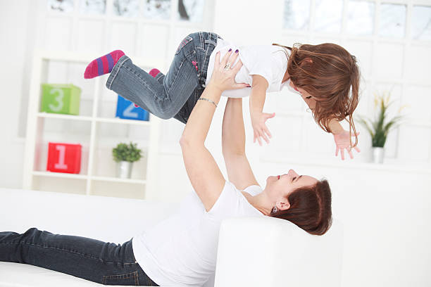 istock Mother holding a child in the air 477986597