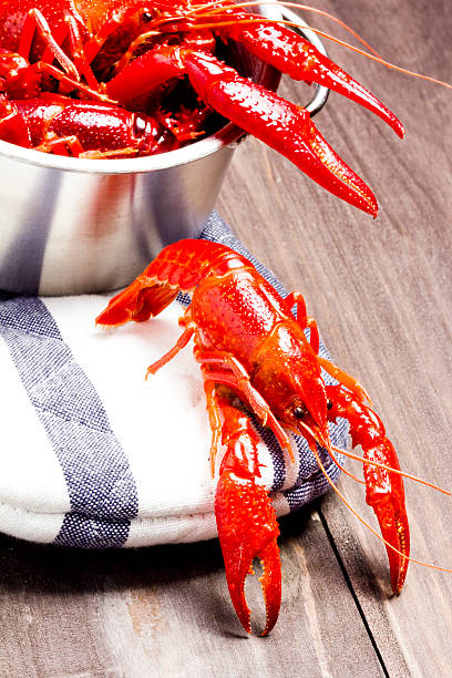 istock Boiled crayfish in steel pot on wooden table background 477988446