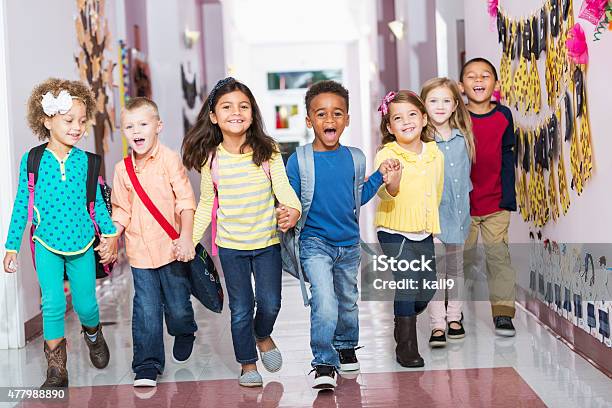 Multiracial Group Of Preschoolers Running Down Hallway Stock Photo - Download Image Now