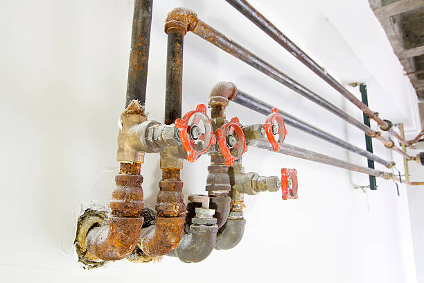 istock Old Plumbing Pipes with Valves on Wall 477989225