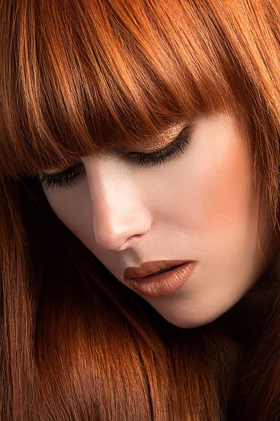 istock Beautiful red haired girl looking down portrait 477989698
