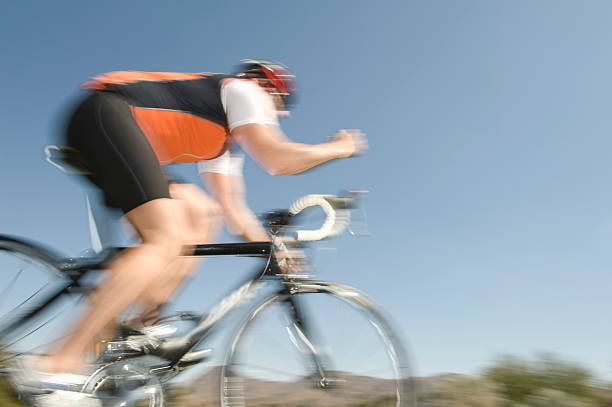 istock Middle Aged Man Riding Bicycle Against Blue Sky 477991449