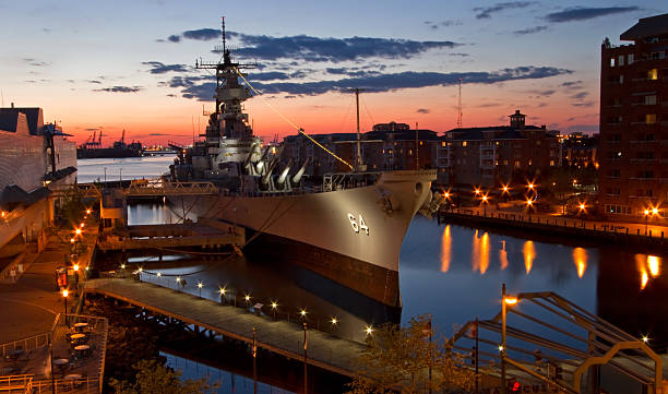 USS Wisconsin Battleship (BB-64) in Norfolk, Virginia, at sunset Overhead view of the battleship USS Wisconsin at twilight, the ship was decomissioned in 1991, and is currently docked in Norfolk, Virginia. us navy stock pictures, royalty-free photos & images
