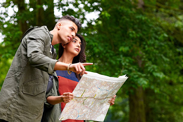 istock Young couple with map looking for directions 477993051