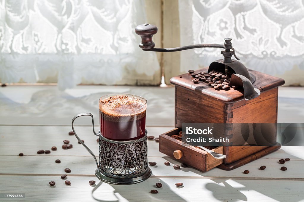 Freshly roasted ground coffee and old grinder Freshly roasted ground coffee and old grinder. 2015 Stock Photo