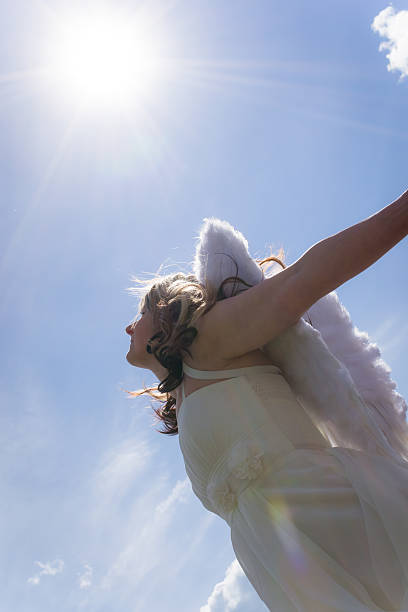 istock Angel woman with sky and sun 477994754