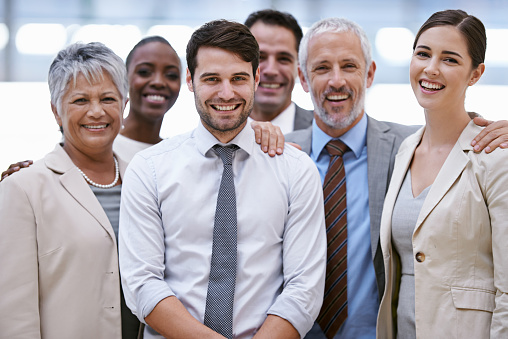 Cropped portrait of a diverse group of businesspeople standing with their arms crossed in their office