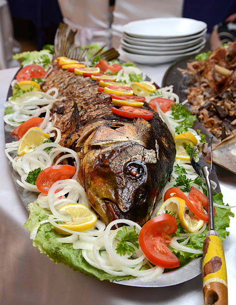 istock Big Fried Fish Carp With Salad On A Plate 477995948