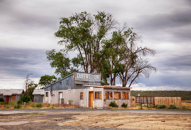 Desolate Drive In Motel An old drive in motel and restaurant near the outskirts of Ephrata in the high desert of Eastern Washington has been boarded up and abandoned. roadside motel stock pictures, royalty-free photos & images
