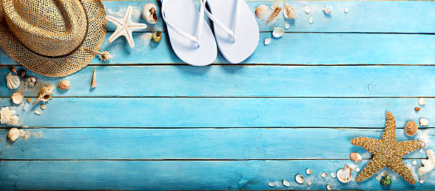 istock sandals an hat for rest on beach with seashells 477996202