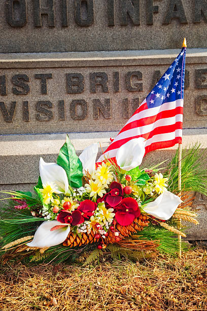 istock Flowers and American flag at war memorial 477996477