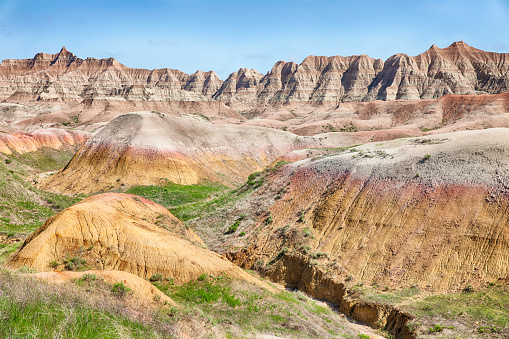 A view of the colored mounds in one of the valleys of the Badlands National Park in South Dakota that shows off the range of colors in the hills.