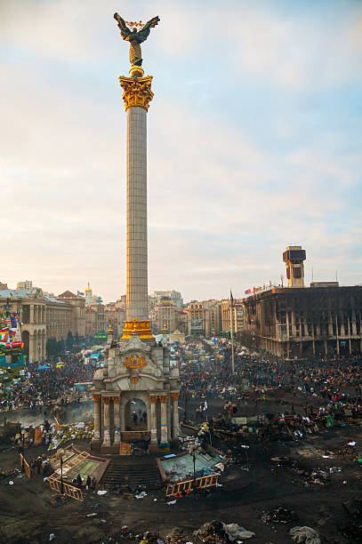Kiev, Ukraine - February 20, 2014: Maidan (Independence) square with people during the revolution. The anti-governmental protests were provoked when the Ukrainian president denied to sign an agreement with the EU.