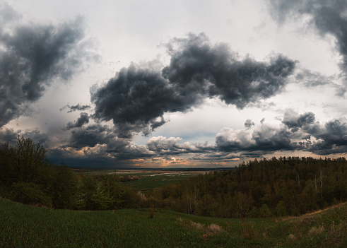 Dramatic sky before thunderstorm. Landscape of meadow.