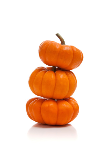 A stack of pumpkins on a white background