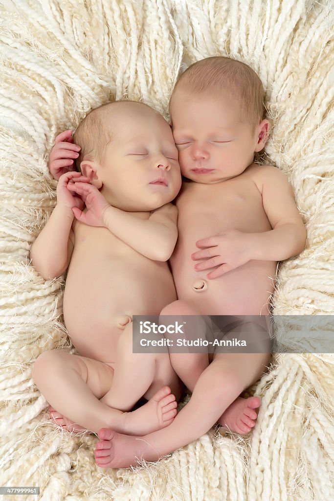 Twin babies on fringe blanket Ten days old newborn twin babies asleep together Newborn Stock Photo