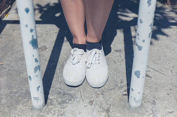 istock Legs of young woman by bars 478002530