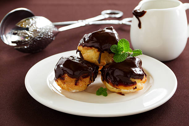 istock profiteroles with cream and chocolate sauce. 478003085