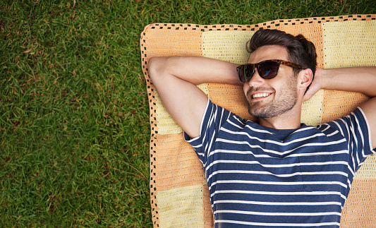 Shot of a happy young man relaxing on the lawnhttp://195.154.178.81/DATA/i_collage/pu/shoots/805019.jpg