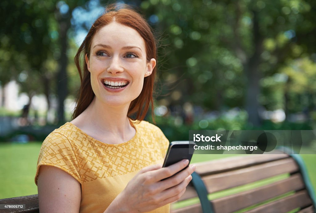 This message says he's somewhere in the park Shot of a happy young woman using her cellphone outdoorshttp://195.154.178.81/DATA/i_collage/pu/shoots/805019.jpg 20-29 Years Stock Photo