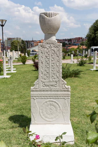 A beautiful statue of a female angel standing in flowers.