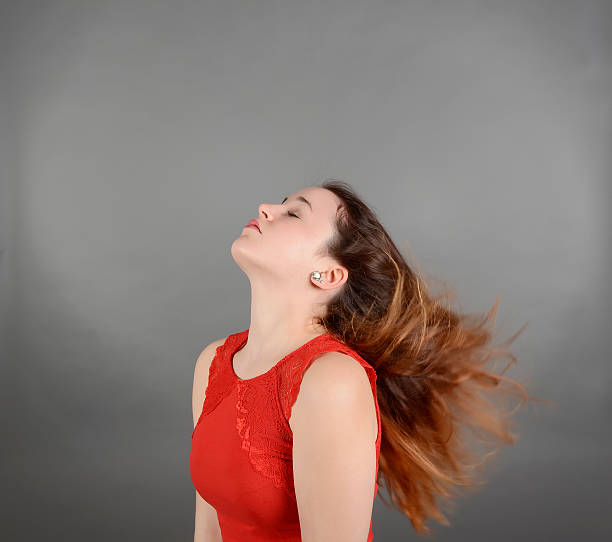 istock Young woman with blowing hair 478005940