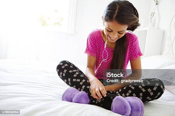 Listening To Her Favorite Band In Her Bedroom Stock Photo - Download Image Now - 2015, Bed - Furniture, Bedroom