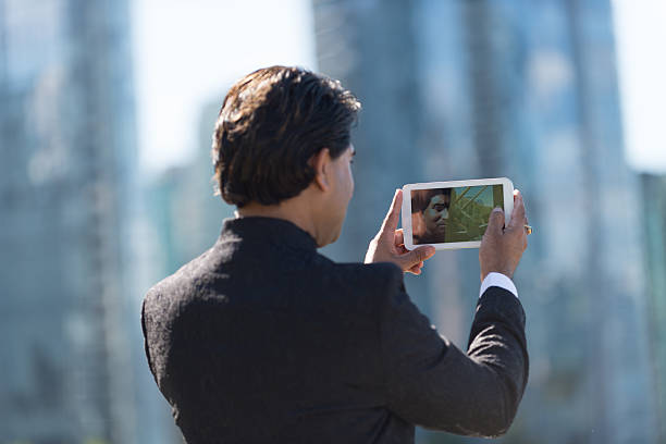istock Businessman in City Taking Photo with Computer Tablet 478007381