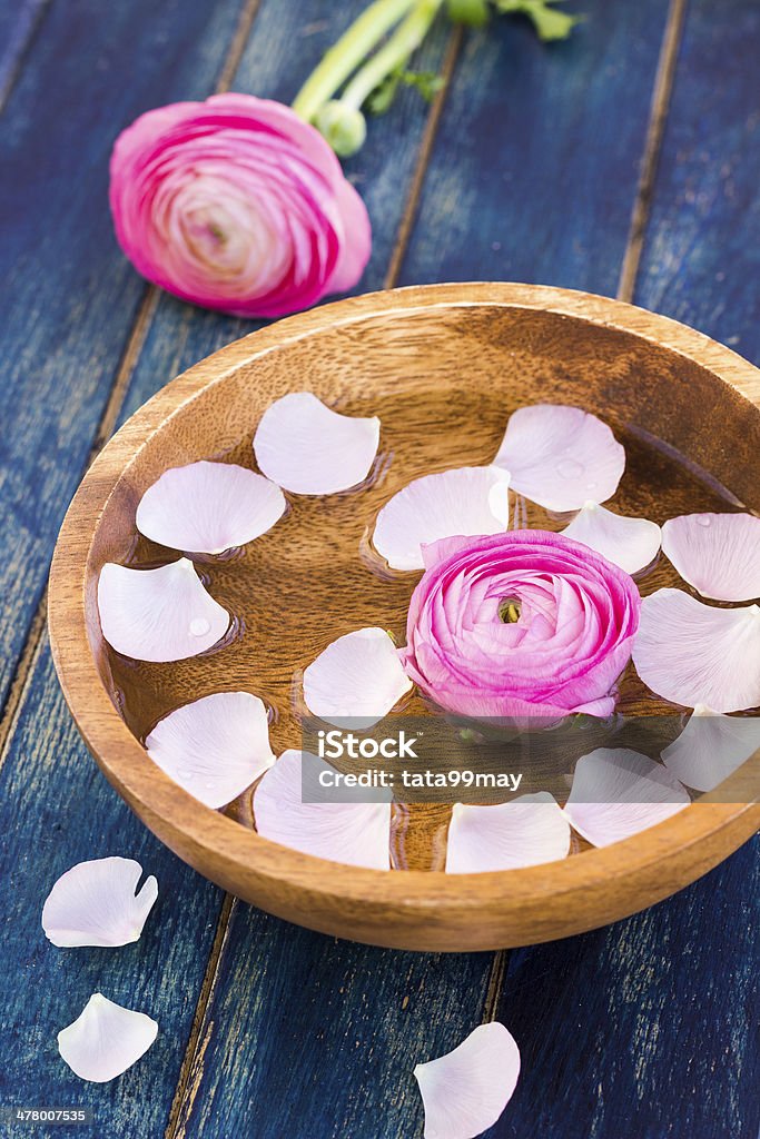 Wooden cup with petals for hands spa Wooden cup with petals for hands spa, selective focus Adult Stock Photo