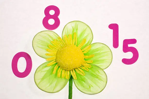 Photo of Numbers 0 8 15 and artificial flowers