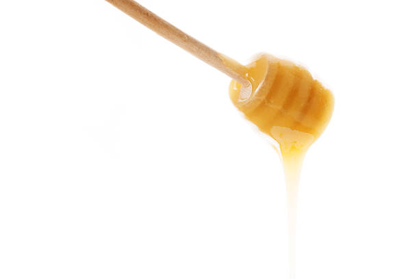istock honey is dripping from the spoon 478011986