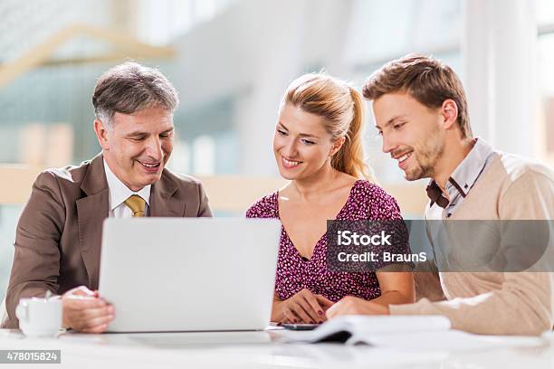 Young Happy Couple On A Meeting With Financial Advisor Stock Photo - Download Image Now