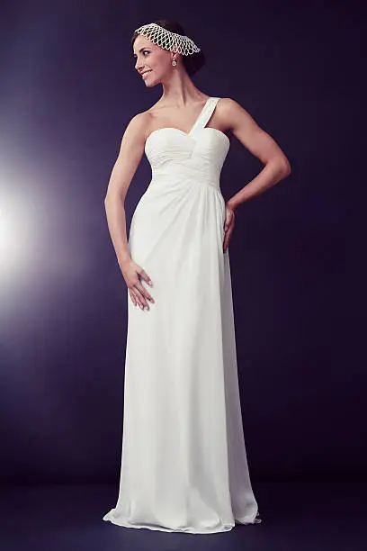 Glamorous young woman in white ballgown