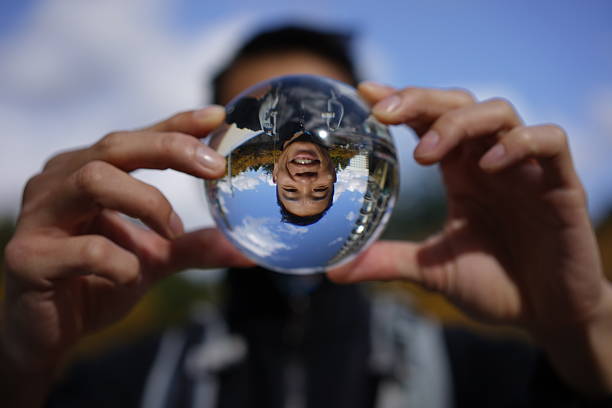Funny image of asian man through a crystal ball stock photo
