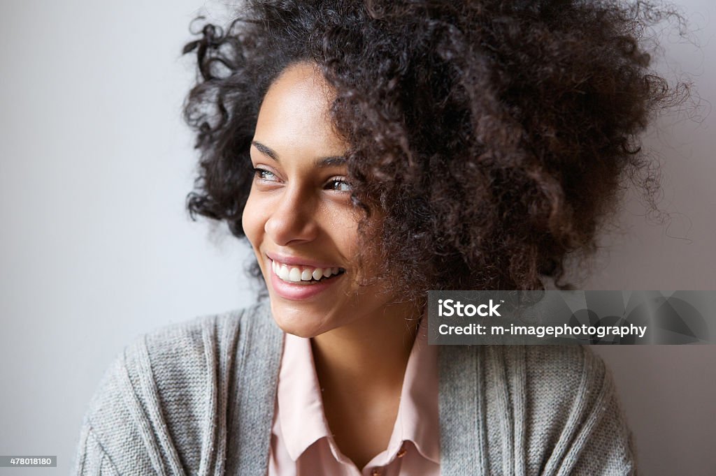 Beautiful black woman smiling and looking away Close up portrait of a beautiful black woman smiling and looking away Candid Stock Photo
