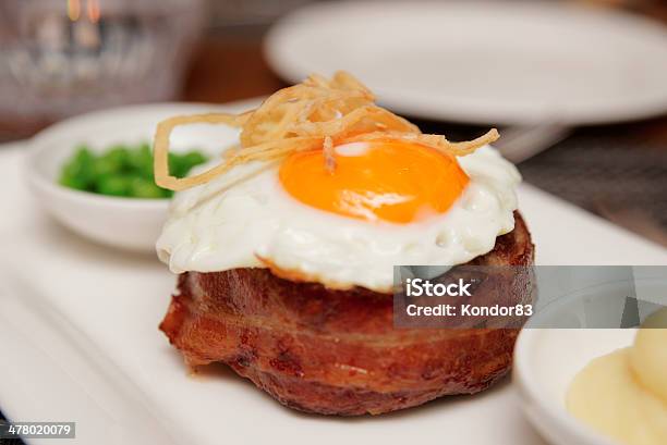 Tenderloin Steak With Fried Egg And Green Pies Stock Photo - Download Image Now - Egg - Food, Tenderloin, Bacon