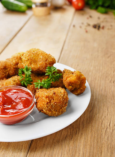 istock Fried chicken nuggets on the plate onto wooden table 478020743