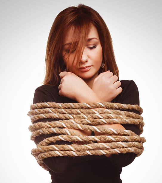 Young woman climbing brick wall, Kalamazoo, Michigan