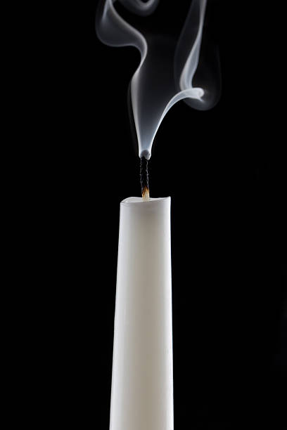 istock extinguished candle with smoke, isolated over black 478024911