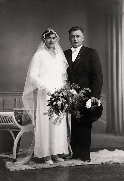 Retro Wedding  - Just married couple in the thirties Vintage portrait of a caucasian couple on their wedding day back in 1934. wedding photos stock pictures, royalty-free photos & images