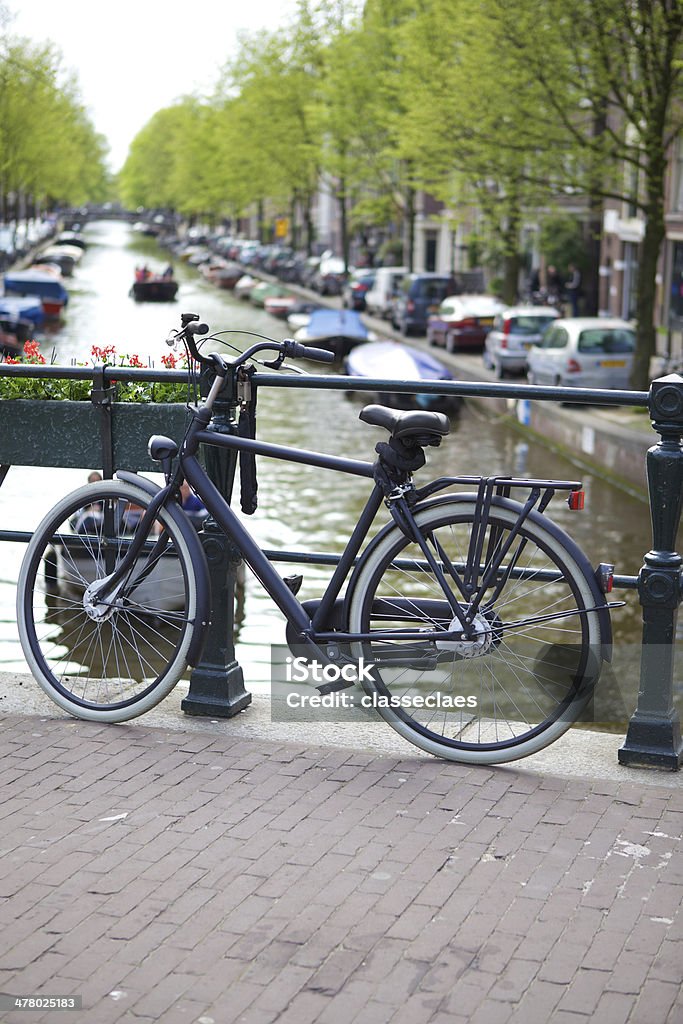Canal and bike in Amsterdam Bike on a canal bridge in Amsterdam Amsterdam Stock Photo