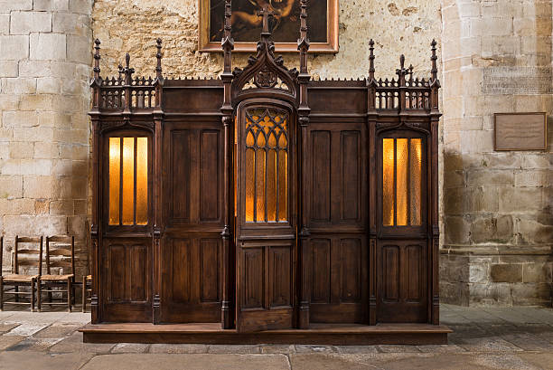 Saint Malo Cathedral confessionary Medieval wood confessionary found inside St. Malo's Church in the Brittany province of France. It's a free service offered to all sinners who want to confess kneelers stock pictures, royalty-free photos & images