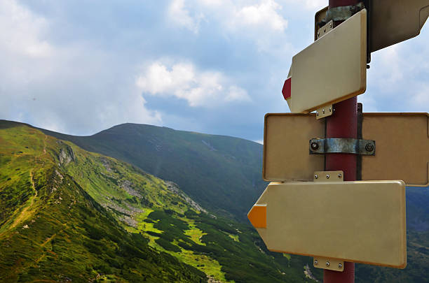istock blank arrow signs on the mountain range sho different directions 478028454