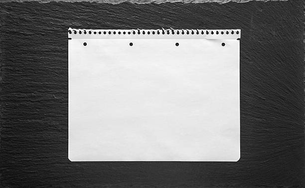 istock White paper sheet on black background. School book page 478028864