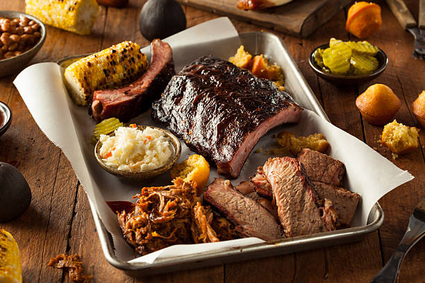 Barbecue Smoked Brisket and Ribs Platter Barbecue Smoked Brisket and Ribs Platter with Pulled Pork and Sides coleslaw stock pictures, royalty-free photos & images